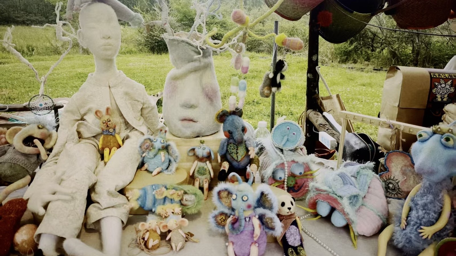Outdoor table with handmade Luna Angel Studio works and soft sculptures.